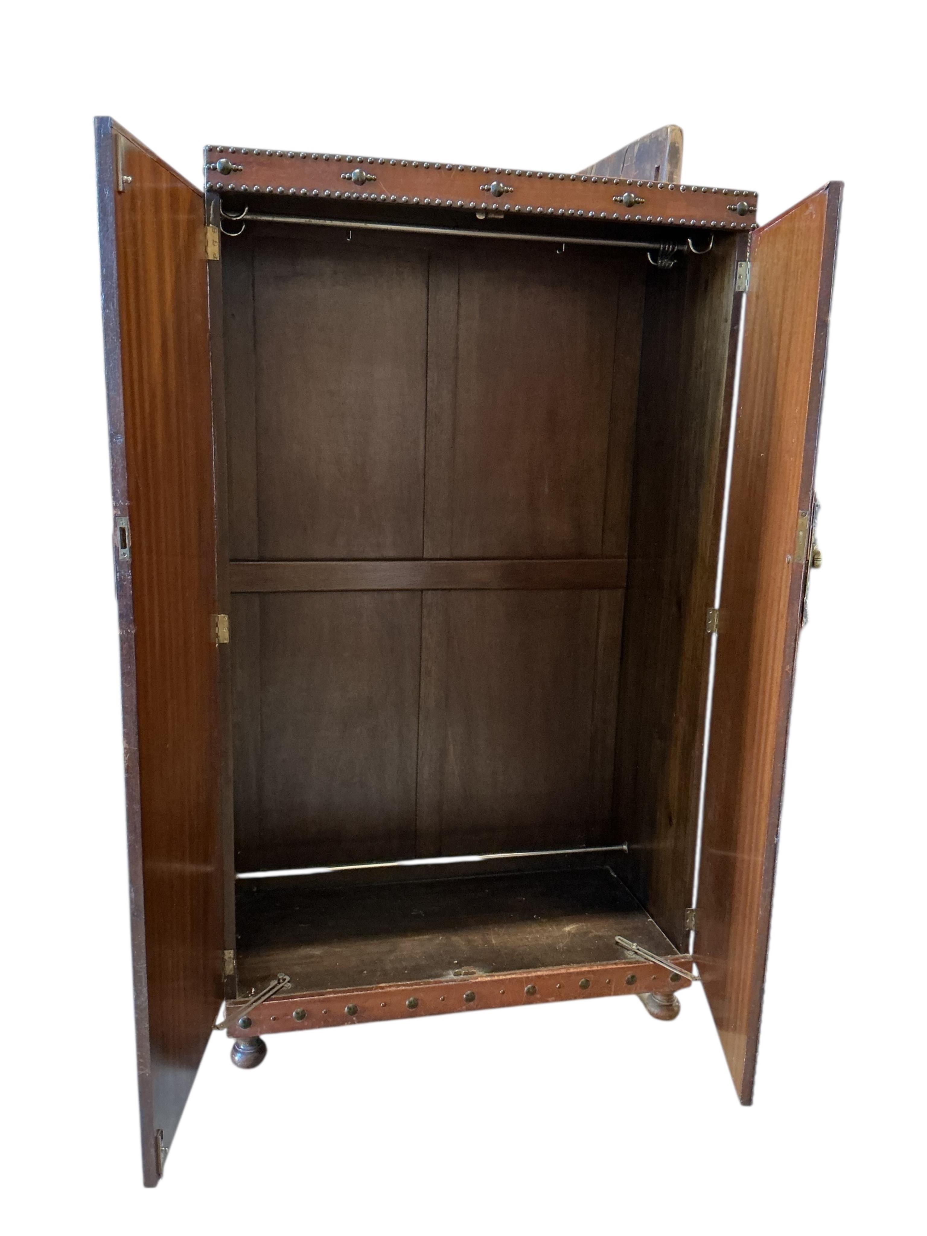 An early 20th century Spanish style studded, tan leather covered two door wardrobe, width 96cm, depth 46cm, height 168cm